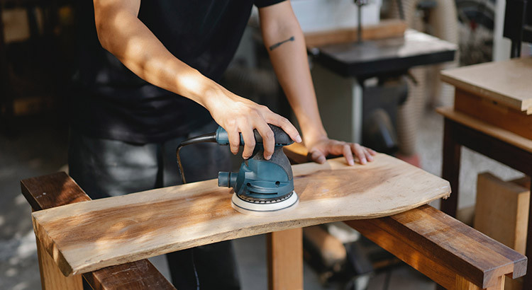 person sanding the wood